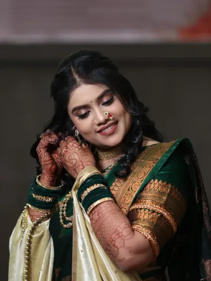 A candid moment of the bride putting on her earrings. The soft makeup look is perfect for a pre-wedding ceremony like a Sakarpuda.