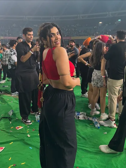 It’s giving Princess Jasmine at a concert. For the Diljit Dosanjh show, I styled this traditional red blouse with comfy black pants and a parandi in my hair. It’s the perfect example of indo-western styling for a fun event.