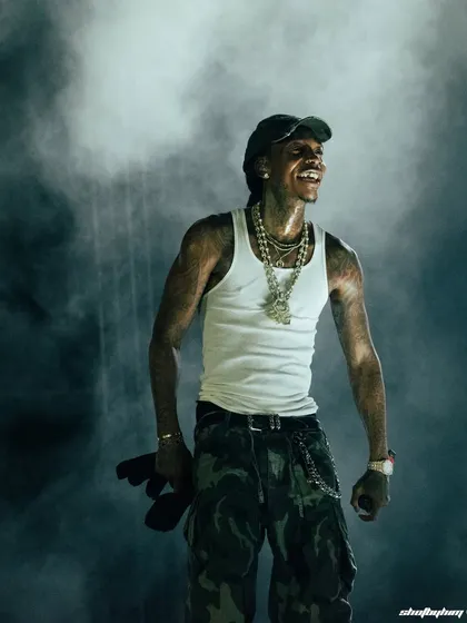 Wiz Khalifa smiles, lost in the moment amidst a cloud of atmospheric smoke at Rolling Loud India. This is the kind of candid shot I live for, capturing the genuine connection between an artist and their music.