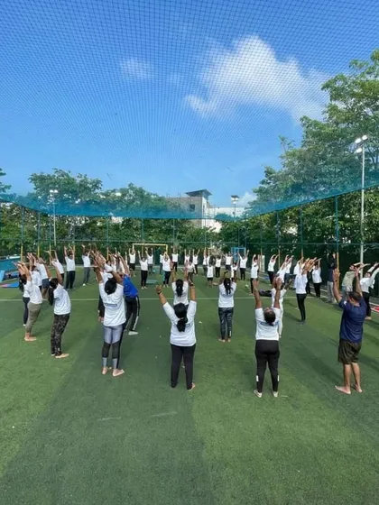 A large group session on an open turf. I am experienced in leading big groups, ensuring everyone feels included and guided throughout the practice.