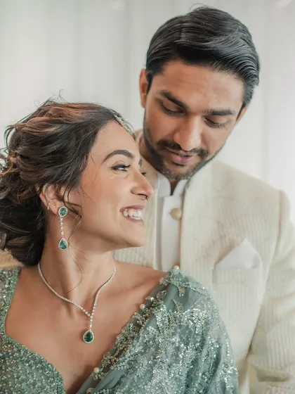 A candid moment between the couple. Her soft, romantic makeup and hair look just as beautiful in a quiet moment as they do in a formal portrait.