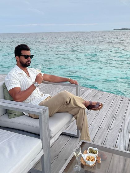 Another view of the relaxed resort wear outfit, perfect for enjoying a glass of champagne with a view of the turquoise water.