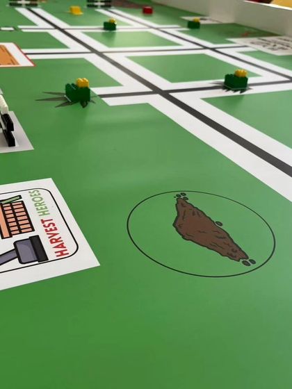 A close-up of the IRO 2024 "Harvest Heroes" challenge mat for the Techies category. This mat presents complex tasks for older students, involving automated farming solutions.