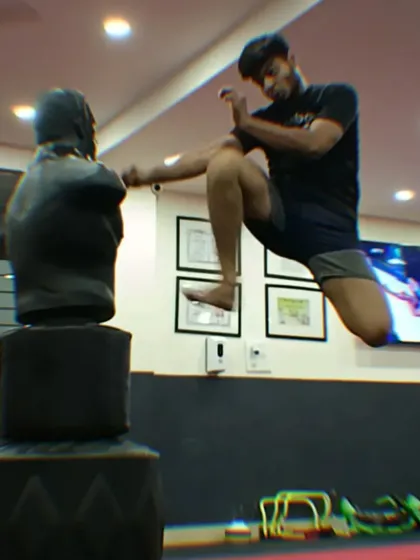 A student executes a powerful flying knee on a training dummy, showcasing the advanced techniques and athleticism you can develop at our academy.