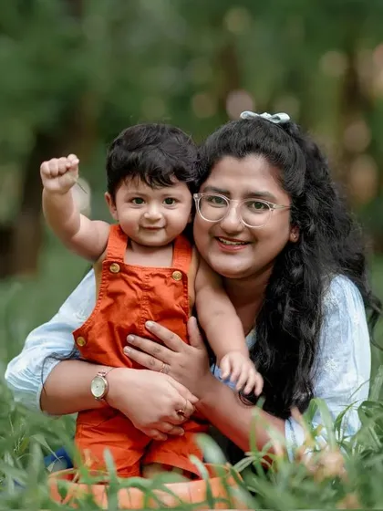 Making memories with our little miracle. This mother and son share a hug in a field of green, a perfect example of a heartwarming mother child portrait.