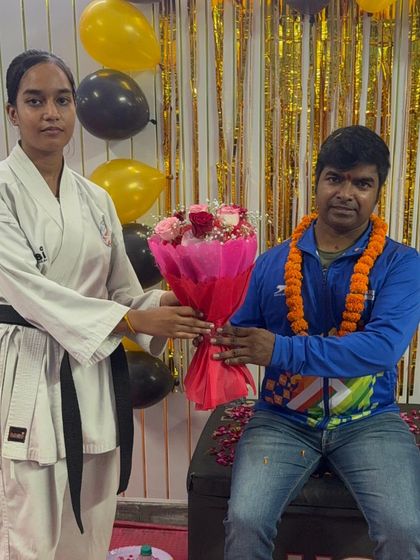 A female black belt student, a role model for others, showing her respect and appreciation for her teachers.