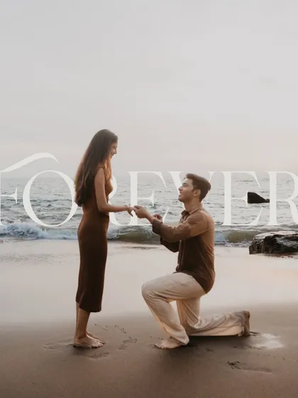 A classic beach proposal against the backdrop of a setting sun and gentle waves. We work with you to find the perfect location and time, using natural light to create a timeless and romantic portrait of your 'yes' moment. This is a perfect example of a scenic destination proposal.