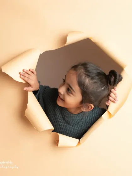 A curious peek. This shot from the paper-tear series captures a moment of playful discovery.