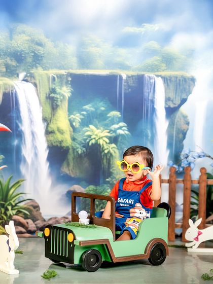 Because every jungle has its own little rockstar. This safari-themed shoot features a cool jeep, a stunning waterfall backdrop, and a happy little explorer ready for an adventure.