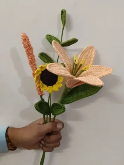 Another custom crochet bouquet, this one featuring a peach lily and a sunflower. We love mixing and matching different flowers to create the perfect arrangement for you.