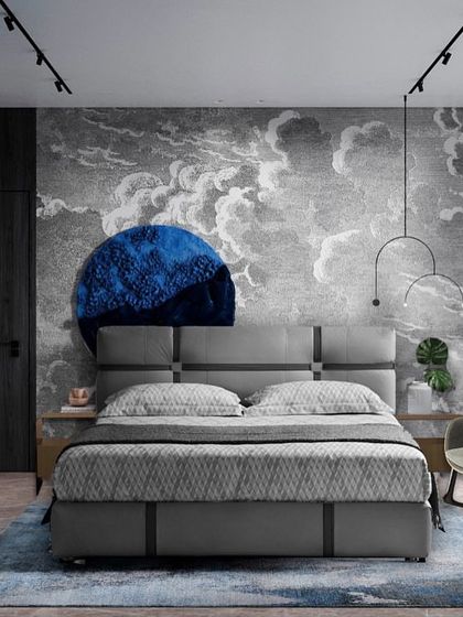 Inspired by a nautical escape, this bedroom features a dramatic cloud-mural wallpaper. The deep blue circular art piece and grey upholstered bed create a serene, dreamy atmosphere reminiscent of the sea.