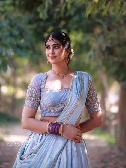 There is a serene elegance in traditional wear, especially when bathed in soft, natural light. This outdoor portrait captures the grace of a modern woman embracing her heritage, blending cultural beauty with a gentle, personal narrative.