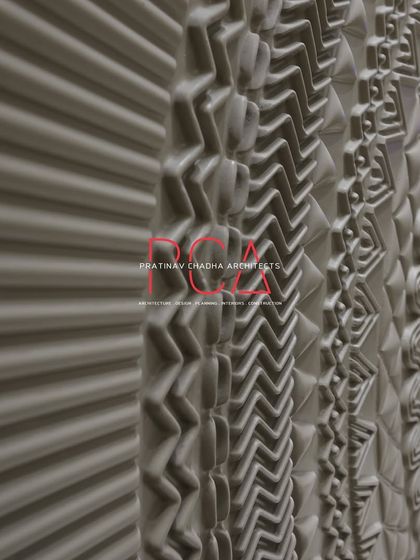 An angular, close-up view of the main door's CNC-milled patterns. This perspective emphasizes the three-dimensional quality and the complexity of the various geometric and organic motifs.