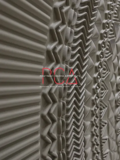 An angular, close-up view of the main door's CNC-milled patterns. This perspective emphasizes the three-dimensional quality and the complexity of the various geometric and organic motifs.