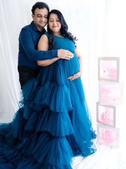A lovely couple's portrait with "GIRL" blocks, making for a sweet gender reveal announcement photo.