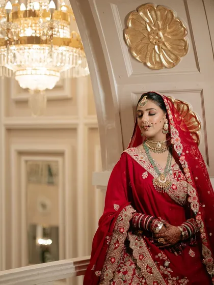 A moment of quiet elegance before the ceremony. Sona's traditional red bridal attire was paired with soft, glowing makeup and intricate jewelry, creating a timeless and royal portrait.