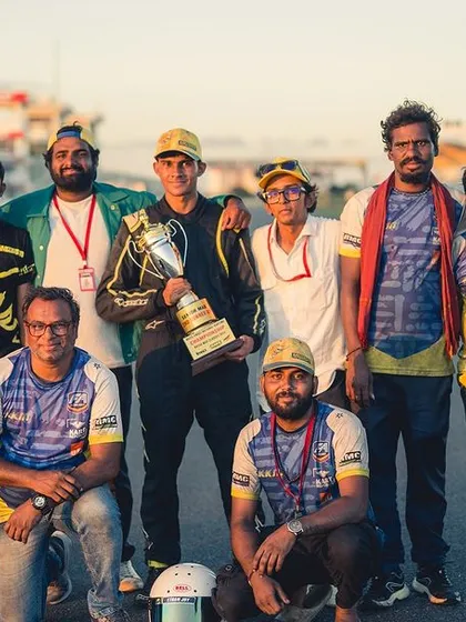The entire Kartkrew Motorsports team with a championship trophy. This victory belongs to everyone.