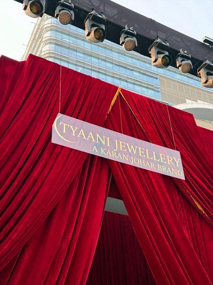 A closer look at the grand red velvet entrance for the Ajio Luxe WKND event. The sheer scale of the drapery, combined with professional stage lighting, created a powerful and glamorous entryway for the fashion showcase.