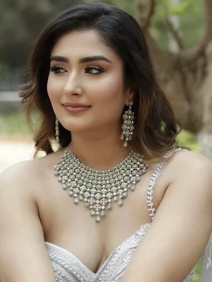 Radiant in silver, this look shimmers like a secret told by stars. The makeup is designed to catch the light beautifully, enhancing the sparkle of the diamonds.