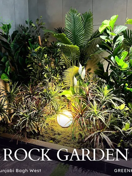 The final rock garden, beautifully lit and professionally photographed. This image shows the stunning result of our plantscaping work, turning a simple corner into a highlight of the property.