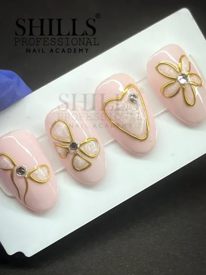 An elegant and romantic set featuring a soft pink base with delicate gold wire-style bows, hearts, and flowers, each accented with a single rhinestone.