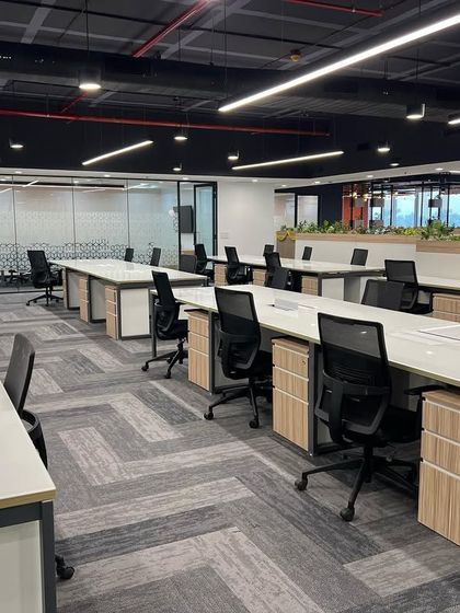 Another view of the Cube Highways office, showing the spacious layout and ample natural light. Low planters are used as dividers, adding greenery without obstructing views.