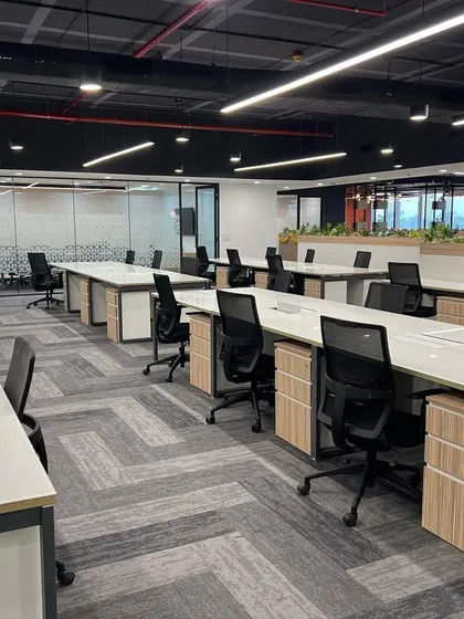 Another view of the Cube Highways office, showing the spacious layout and ample natural light. Low planters are used as dividers, adding greenery without obstructing views.
