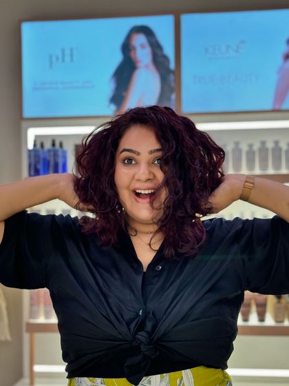 The pure joy of a great hair day. Her curls are bouncy, and the color is exactly what she wanted.