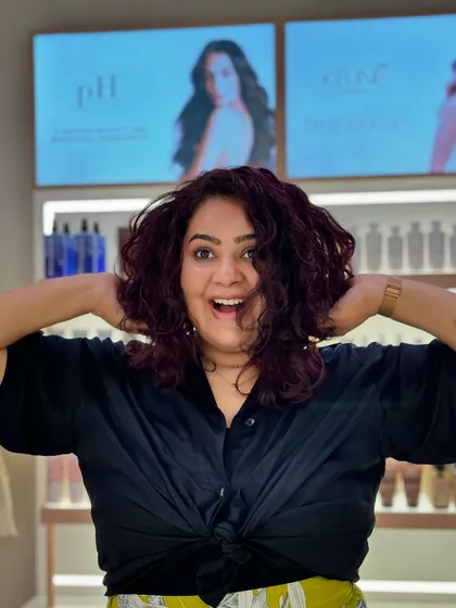 The pure joy of a great hair day. Her curls are bouncy, and the color is exactly what she wanted.