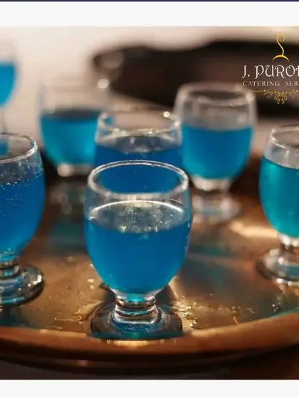 Welcome drinks set the tone for your event. I often serve these refreshing blue mocktail shots in elegant, small glasses as guests arrive. It's a simple touch that makes everyone feel immediately welcomed and ready to celebrate.