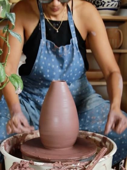 A large, terracotta colored vase I threw on the wheel, a testament to pushing my limits with the weight and scale of clay.