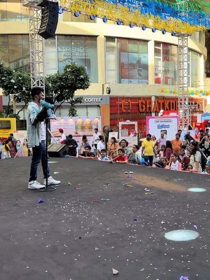 A wide shot of the stage and audience at the R City Mall event.