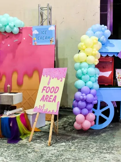 The food and ice cream area at the Candyland party, complete with themed carts and signs.