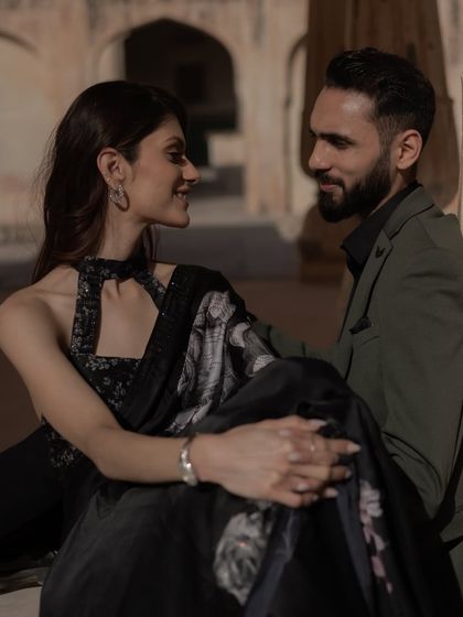 The look of love, captured in a candid moment during a royal pre-wedding shoot. The soft light and historic setting add a layer of timeless romance to this beautiful portrait.