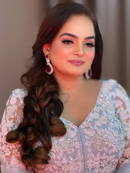 Another angle of this soft glam look. The side-swept curls and delicate eye makeup create a romantic feel, perfect for a wedding guest or bridesmaid.