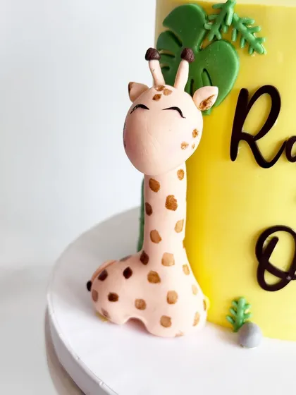 The adorable giraffe from Rajveer's first birthday cake. The hand-painted spots add a touch of realism and charm.