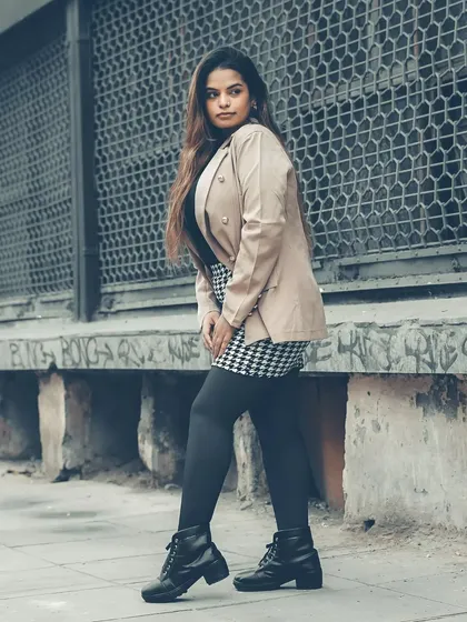 A full-body shot that captures the complete winter street style look. The pose is grounded and strong, making it a great concluding image for the series.
