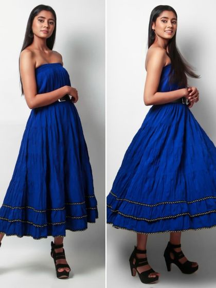 A composite image of a model in a strapless blue midi dress, showing one static pose and one with movement to display the skirt's volume.