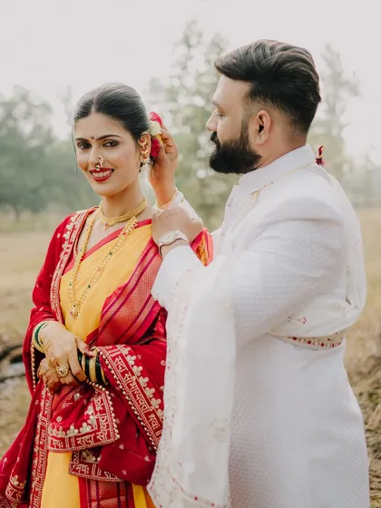 A candid moment during a traditional shoot, where the groom gently places a flower in his bride's hair. It’s these small, unscripted gestures of love that I aim to capture, showing the couple's bond amidst the beauty of their cultural attire.