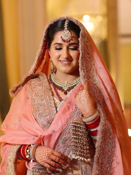 A close-up of the peach bridal look, showing the soft, shimmery eye and the flawless, glowing skin.