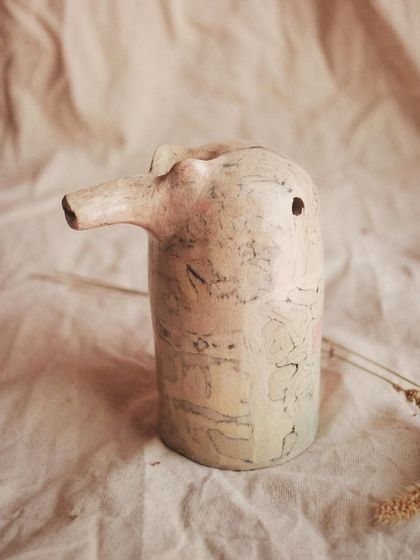 A different view of the Nerikomi pajarito, showing the subtle patterns created by layering black and pink clays.