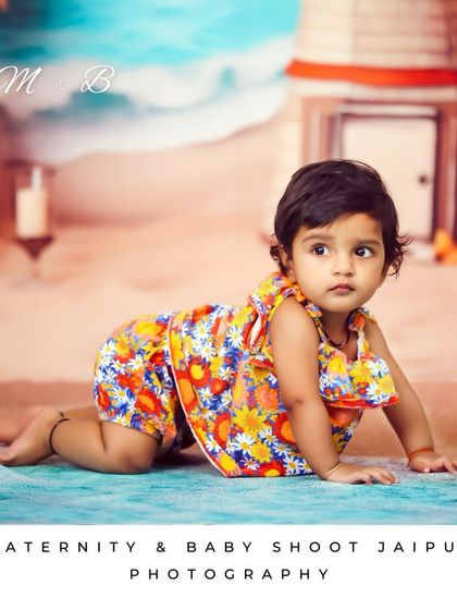 Capturing the crawling phase during a beach-themed shoot. The colorful outfit and detailed backdrop make this a vibrant and memorable baby portrait.
