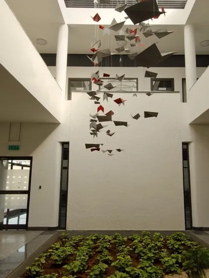 For the Torishima Pumps corporate office, we created a multi-story atrium that serves as a bright and welcoming central hub. The suspended art installation and indoor garden bed establish a professional yet creative brand identity from the moment one enters the building.