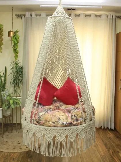 This swing in a natural color is paired with red pillows and a printed mattress, showing how you can mix and match to create a look that is uniquely yours.
