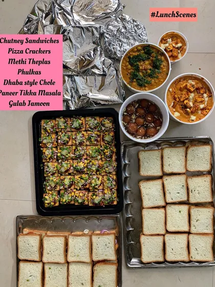 A lunch order with Chutney Sandwiches, Pizza Crackers, Dhaba style Chole, and Paneer Tikka Masala.