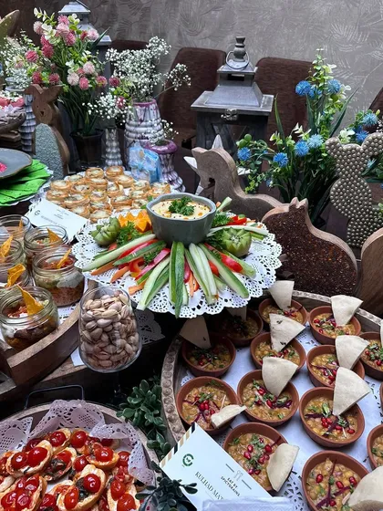 Another view of our beautiful baby shower grazing table. We combine different textures and serving styles, from rustic wooden trays to delicate doilies, to create a visually rich and inviting setup.
