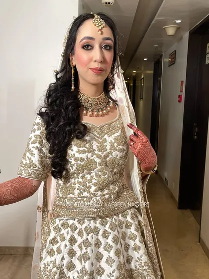 No filter, no edits, just raw clicks of this stunning bride. She is wearing a beautiful white and gold lehenga, and we created a soft glam look with defined eyes and a nude lip.