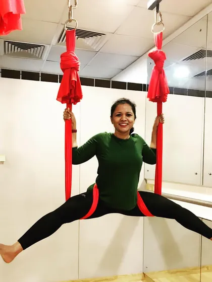 A happy student enjoying an aerial split. Seeing this progress and confidence is the most rewarding part of being a teacher.