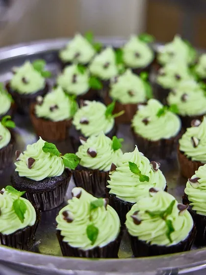 A tray of our popular mint chocolate cupcakes, ready to be served. The combination of rich chocolate and cool mint is a classic pairing that never fails to delight.