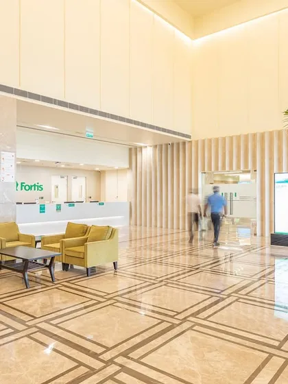 In the Fortis Hospital in Greater Noida, a converted hotel, the lobby retains a sense of hospitality. We used warm, indirect lighting and comfortable seating clusters to create a relaxed atmosphere, reducing the institutional feel.